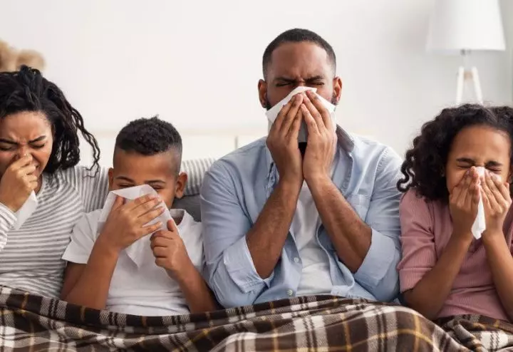 FeaturedImage-family-sick-at-home-under-blanket.jpg
